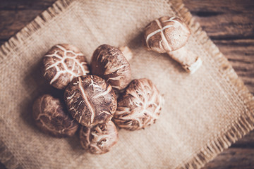 Shiitake mushroom on sackcloth and wooden background