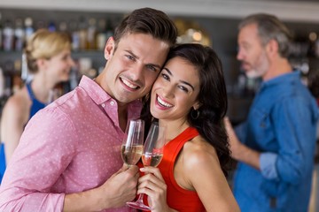 Couple embracing each other while having wine