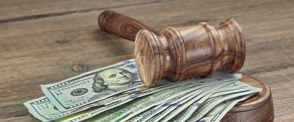 Judges or Auctioneers Gavel And Money Stack On Wooden Background
