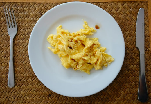 Scrambled Egg with Sauce in White Plate. Delicious Breakfast.