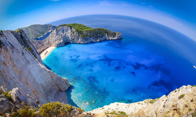 Zakynthos shipwreck beach. Navagio Bay panorama with boats and c