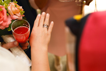 Wedding and engagement ring on delicate bride's hand