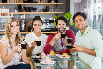 Group of friends having cup of coffee together