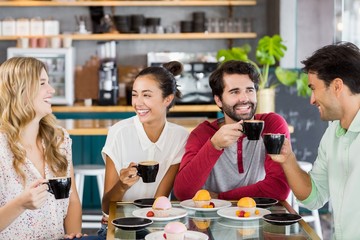 Group of friends having cup of coffee together