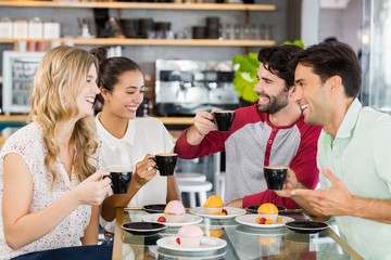 Group of friends having cup of coffee together