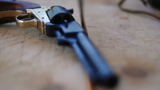 Duplicate of the Colt Peacemaker lying on a wooden table, the legendary American gun during the civil war.