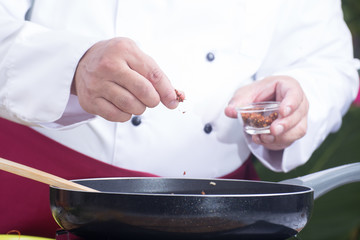 Chef putting deied chili for cooking Pad Thai
