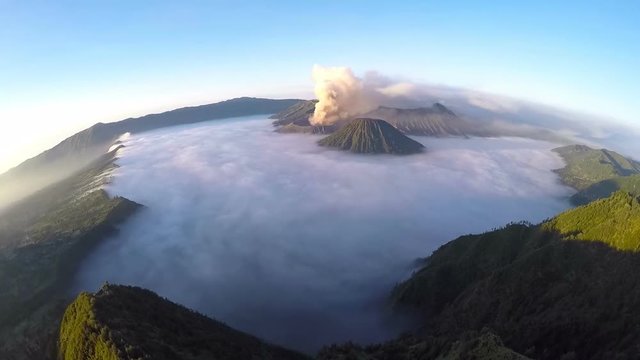 Aerial view flight over Mount Bromo volcano during sunrise, the magnificent view of Mt. Bromo located in Bromo Tengger Semeru National Park, East Java, Indonesia.