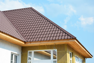 Roofing house and insulation detail. Building insulation exterior, added to buildings for comfort and energy efficiency. Soffit and Fascia installation.