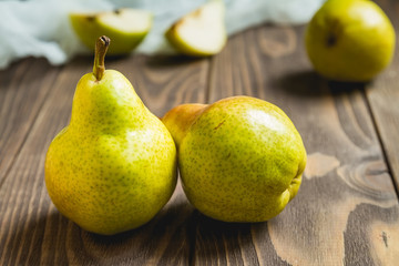 green fresh pears on a rustic table