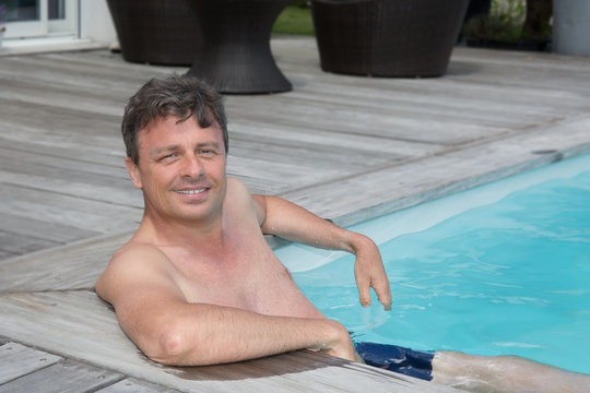 Portrait Of A Mature Man Sitting In The Swimming Pool