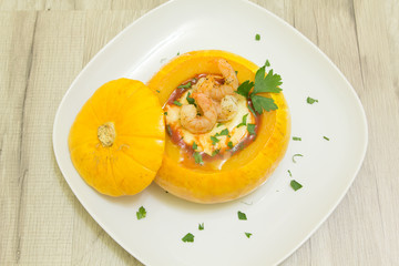 Baked whole pumpkin with shrimp and cheese