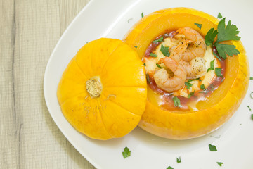 Baked whole pumpkin with shrimp and cheese