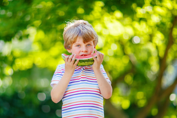 little preschool kid boy eating watermelon in summer