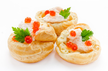 Profiteroles with fish mousse or pate and red caviar close up