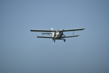 Fototapeta premium The spraying of fertilizers and pesticides on the field with the aircraft.