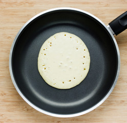 Making pancakes on frying pan