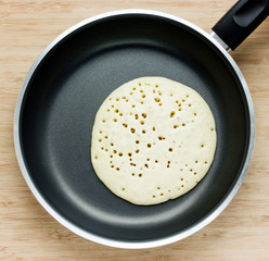 Making pancakes on frying pan