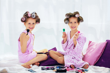 happy little girl sitting and playing in the spa salon