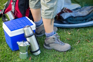 Female hikers feet with picnic essentials