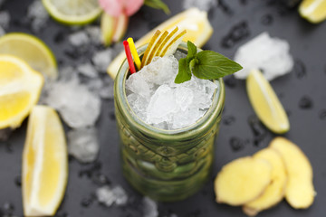 Tropical cocktails served in a tiki style glass and garnished with fruits and ice