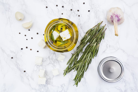 Glass of diced sheep cheese pickled in olive oil, thyme, garlic, pepper and rosemary