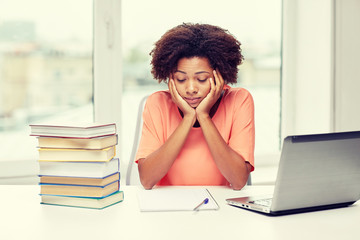 bored african american woman doing homework home