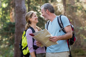 Happy hiker couple looking at each other