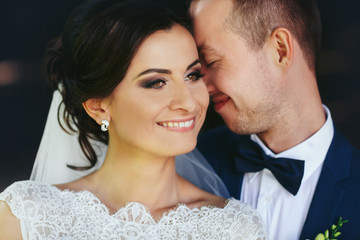Groom leans to a perfect bride's face