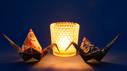 Origami peace cranes and a candle - 116873902