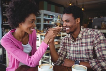 Young couple feeding each other