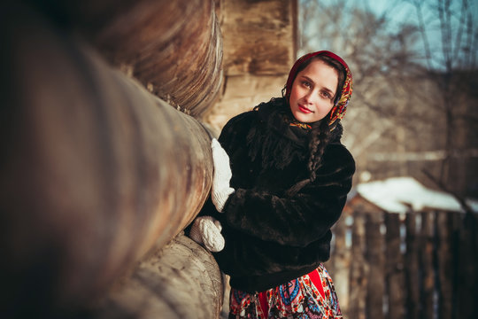Russian girl in the village in winter