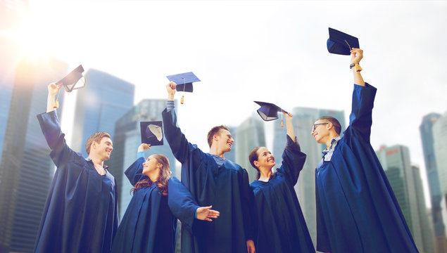 group of smiling students with mortarboards