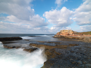 Fototapeta na wymiar Long exposure shot on amazing rocks and sea waves