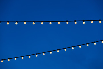 string light bulb  hanging for decorative night party and blue sky background