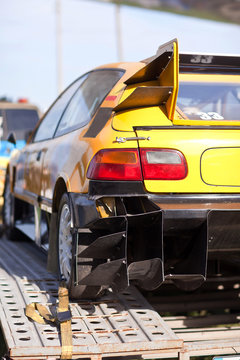 Rearlights of yellow sport car with black diffuser
