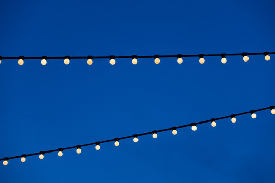 String Light Bulb  Hanging For Decorative Night Party And Blue Sky Background