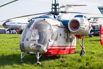 Fototapeta na wymiar Russian helicopter standing on the grass with the engine OFF