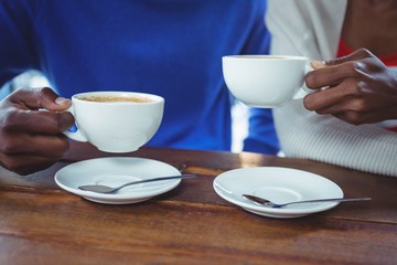 Mid section of couple having coffee