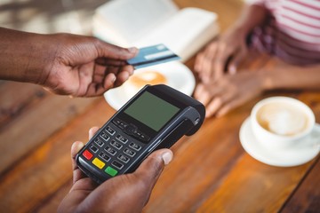 Waiter holding credit card machine