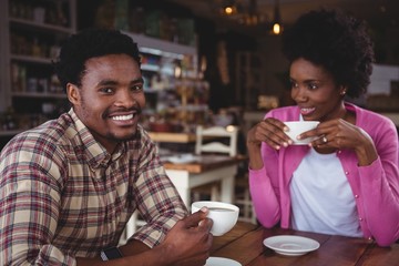 Young couple having coffee in cafeteria