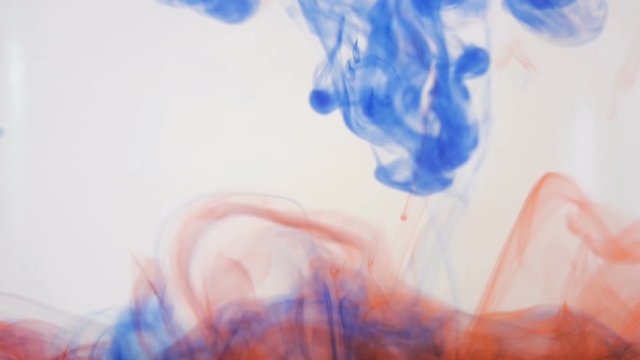 Bright colorful background. Blue and red Liquid ink colors blending in water. Slow motion.
