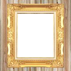 Antique gold frame on wooden wall background