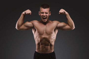 Fototapeta na wymiar Healthy muscular young man screaming. Sport portrait. Emotion.