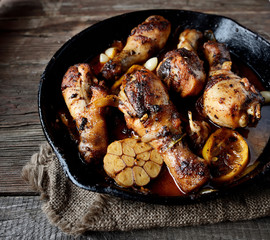 fried chicken legs in a pan. rustic style