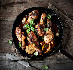 fried chicken legs in a pan. rustic style