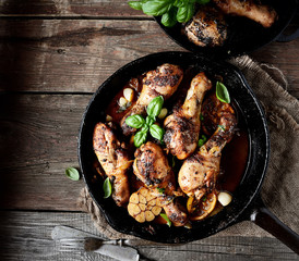 fried chicken legs in a pan. rustic style