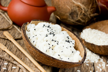 Sweet coconut rice pudding in half coconut shell