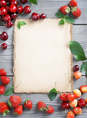 Deluxe berries background. Photography of cherry and strawberries on wooden table. Copy space. High resolution product. Harvest concept.