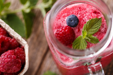 Top view on healthy berry smoothie in glass jar.